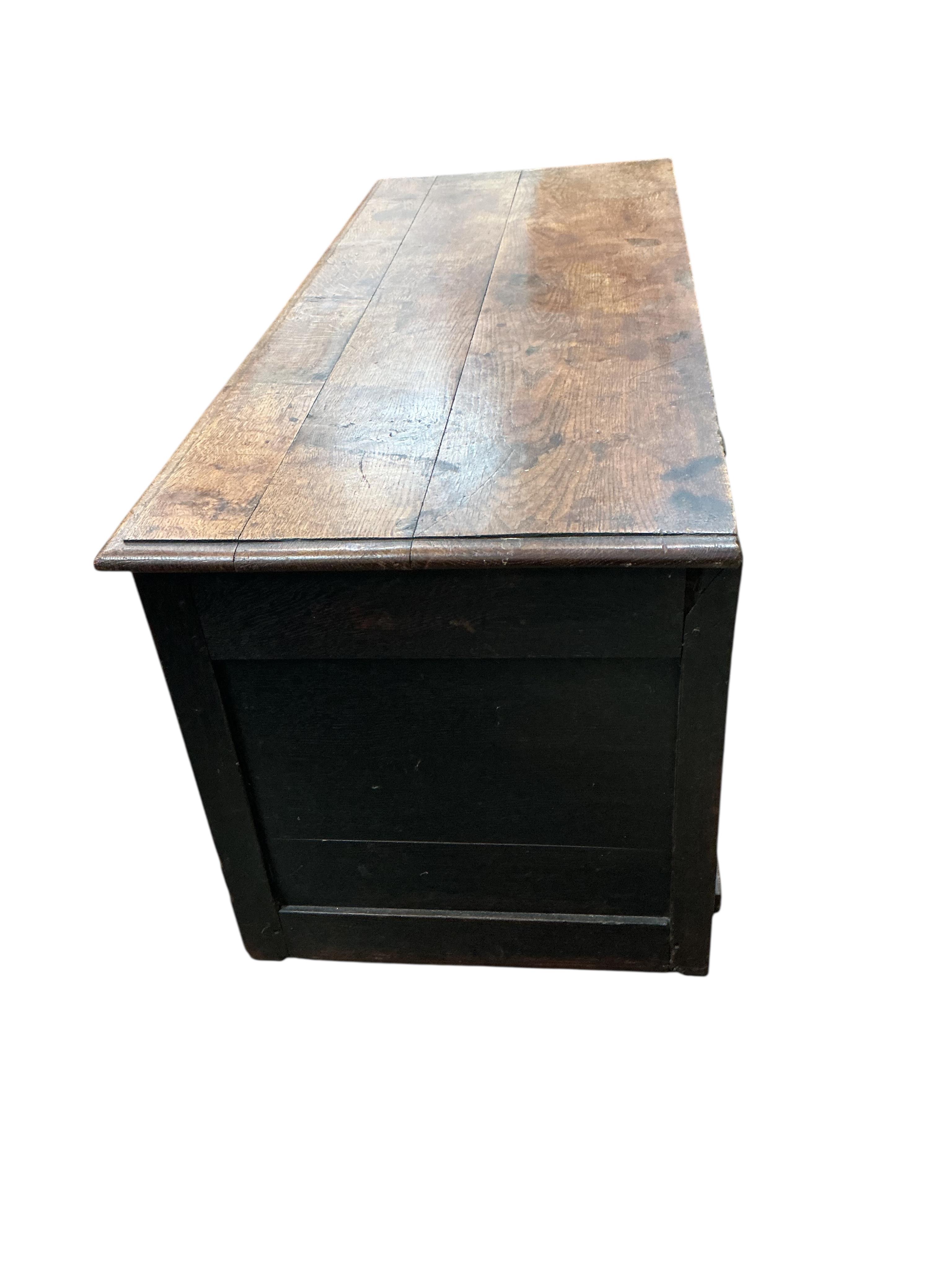 An 18th century panelled oak coffer, width 136cm, depth 54cm, height 56cm